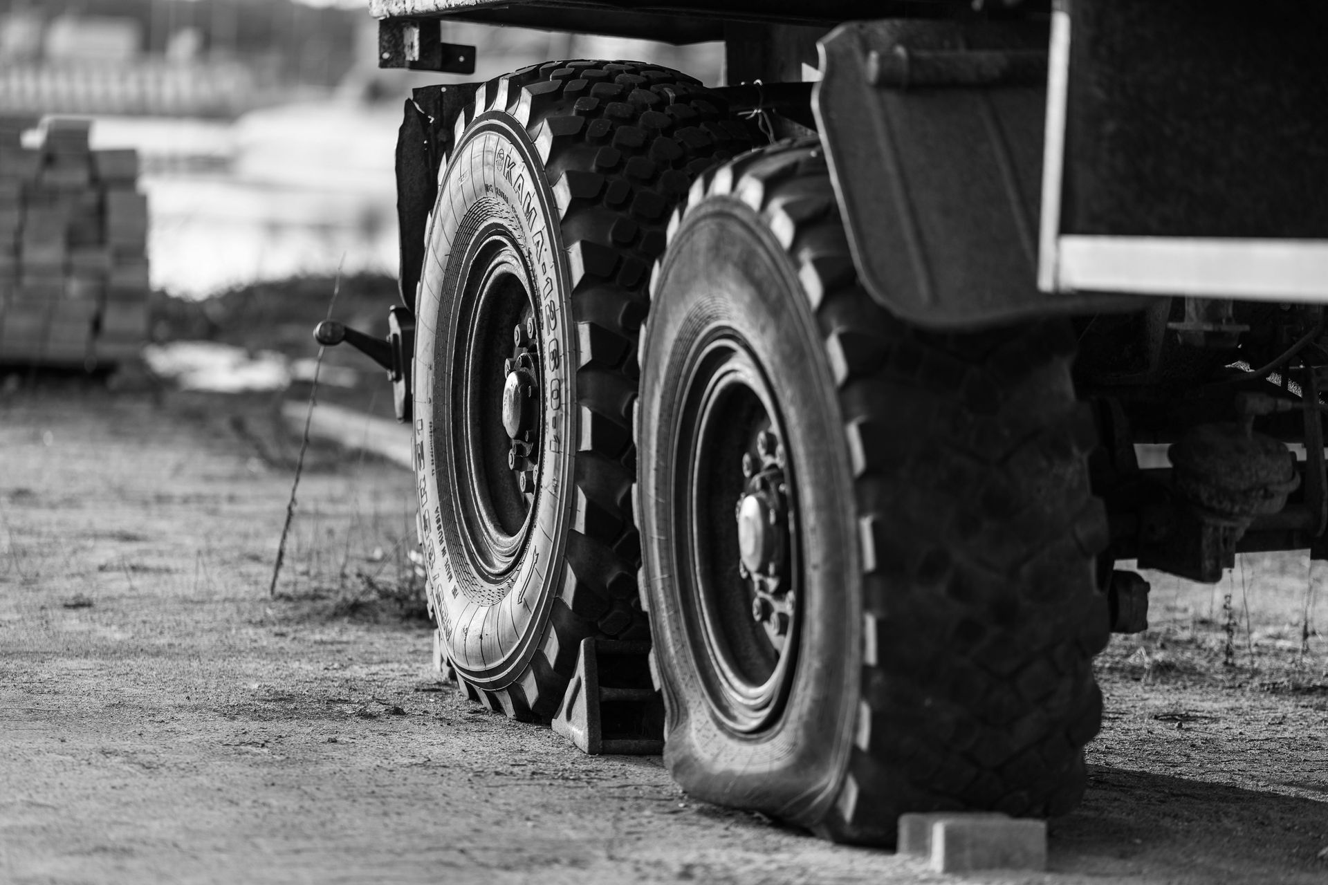 A Line Of White Box Trucks And Cargo Vans Parked In A Row Outdoors — THG Tires in Gladstone Central, QLD