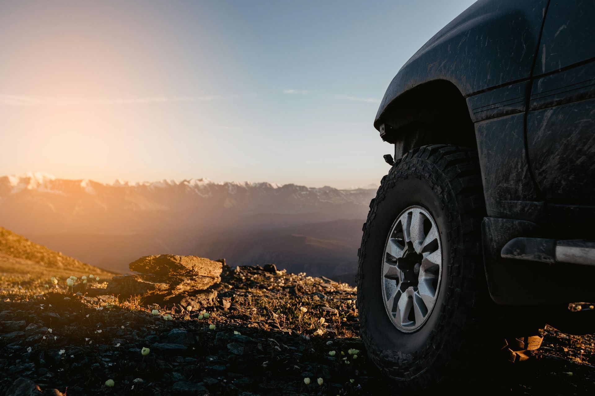 A Black Off-road Vehicle Sits On A Gravel Path — THG Tires in Gladstone Central, QLD