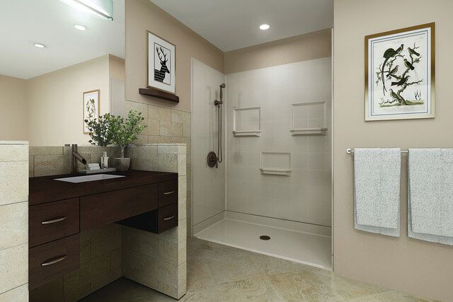 Modern beige bathroom with vanity, shower, towels, and framed wall art