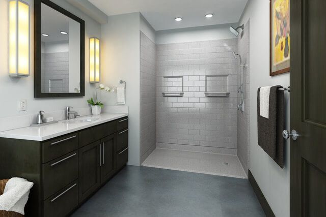 Modern bathroom with black vanity, white sink, gray tile shower, and wall mirror lights