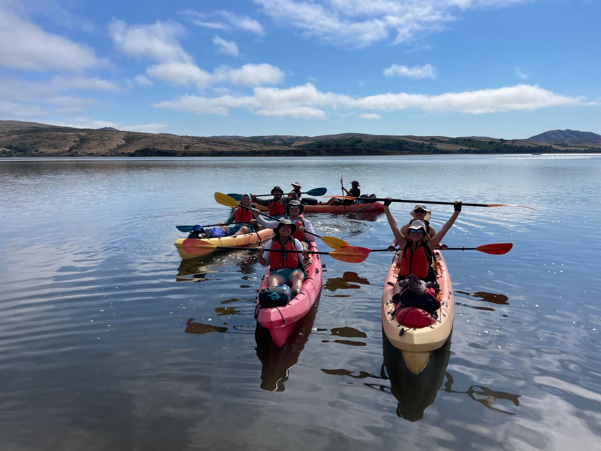 A group of people in kayaks on a lake