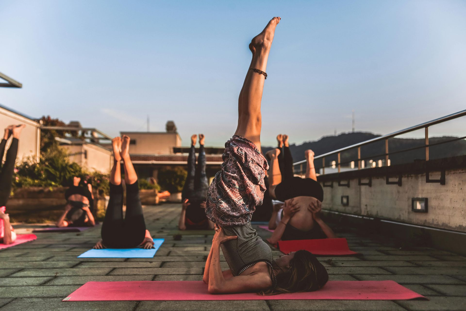 A group of people are doing yoga on a rooftop.