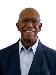 Smiling man wearing glasses, blue shirt, and navy blazer, against a white background.