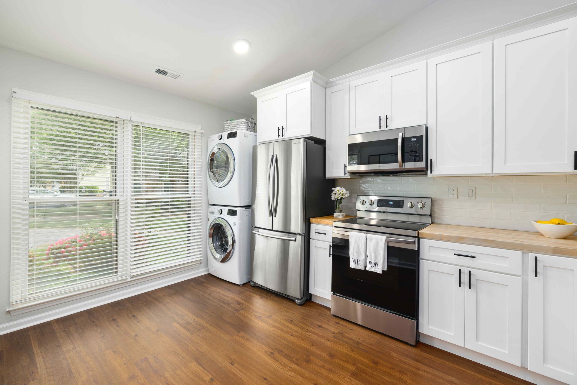 modern kitchen with large windows with washer and dryer