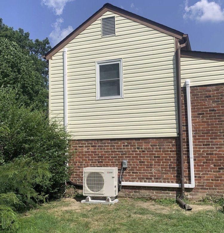 A house with a brick wall and a white siding