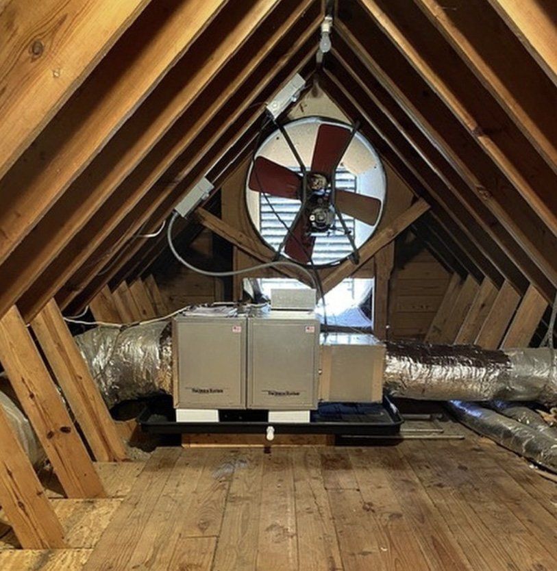 An attic with a fan hanging from the ceiling