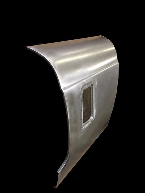 Metal car door panel with window opening, isolated against a black background.