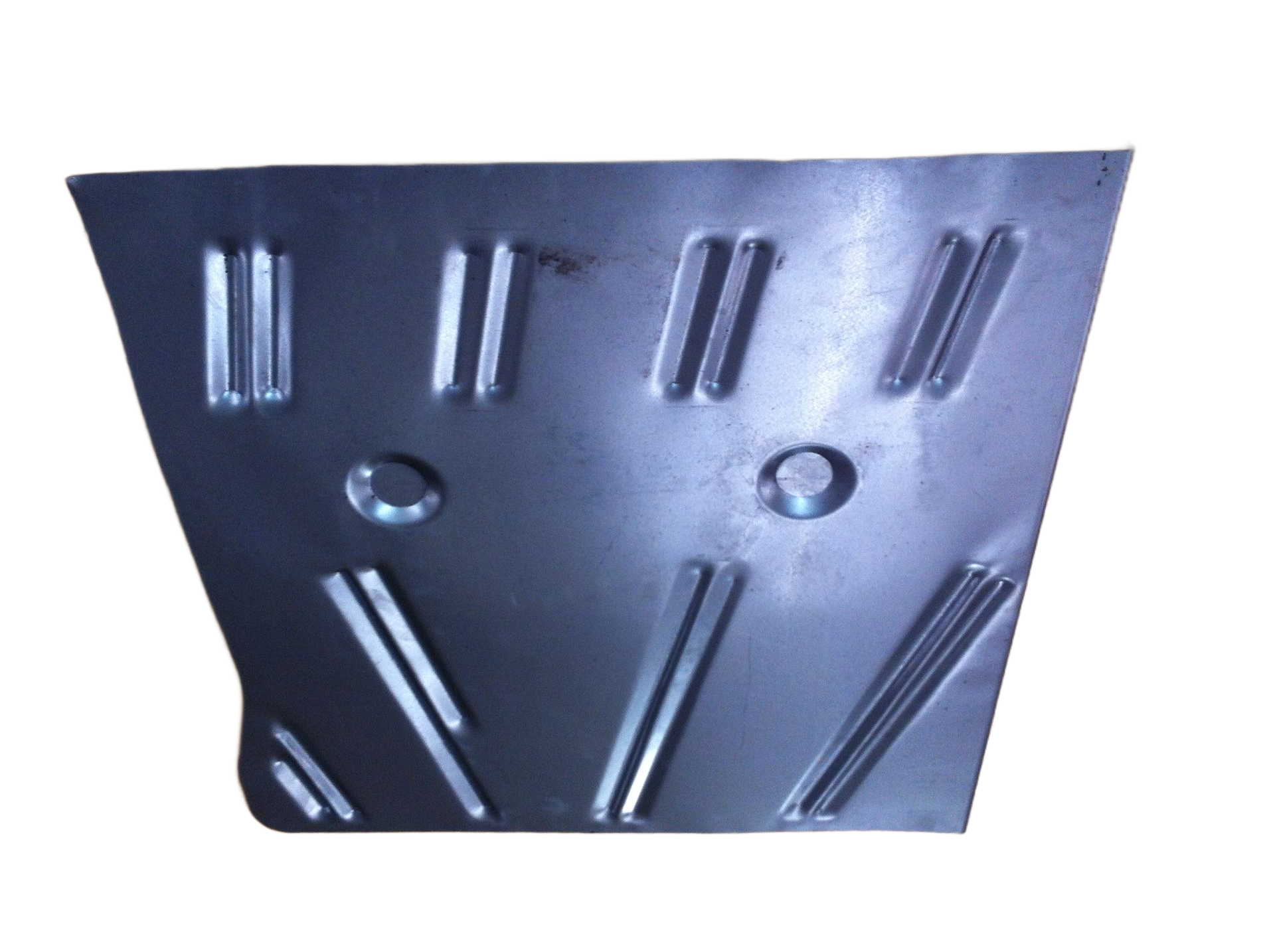 Metal vehicle floor panel with raised ribbing and holes.