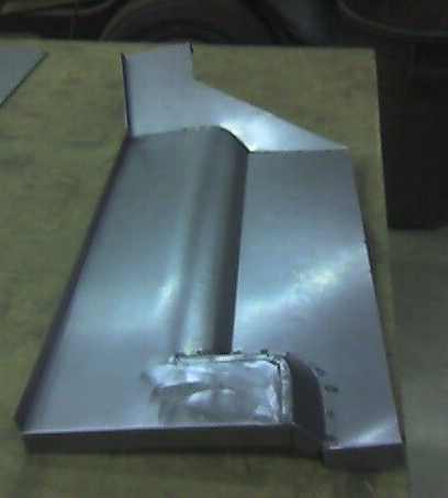 Metal car panel with a central curved section and welded base.