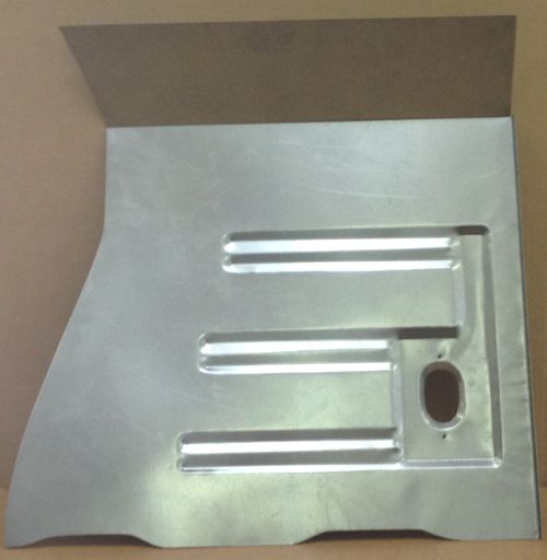 Metal panel with three horizontal slots and an oval hole. Brown cardboard is attached at the top.