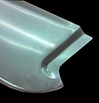 Red painted car panel, likely a door.