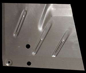 Metal car floor panel with stamped reinforcements and two holes.