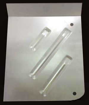58-60 thunderbird  front floor pan with three raised, angled slot-shaped stampings The pan has a bent top edge and two holes.
