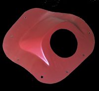 Red plastic shroud with a central hole, several mounting holes, and a curved shape.