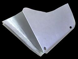 Silver metal blade with bent sides, two holes, and sharp edge on a black background.