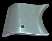 Gray, curved metal panel with a circular hole.