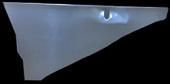 A shiny, light-gray, oddly shaped metal object against a black background.