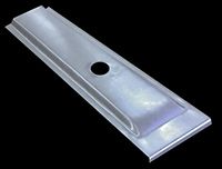 Metal car panel with a central hole and a raised, rectangular design.
