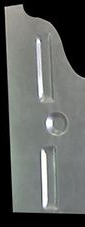 A close-up of a metal bracket with two slots and a circle.