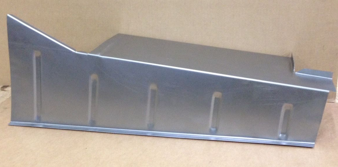 Metal tray with sloping sides and slotted reinforcements, set on a plain surface.