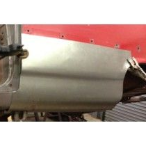 A metal car panel is being installed on a red vehicle in an industrial setting.