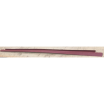 Long, thin, maroon-colored trim pieces, likely for a car, lying on a light surface.
