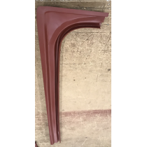 Red metal car body panel, possibly a fender, with curved and angled sections.