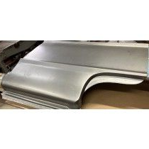 Metal car body panel.  Gray steel, curved shape, for repair or restoration work.