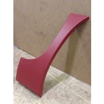 Red, curved plastic car panel, leaning against a neutral-colored surface.
