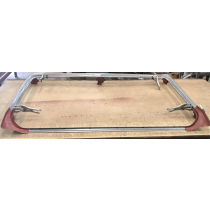 Chrome car roof rack frame with pink end supports.