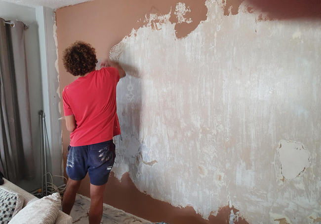 Leon plastering a wall