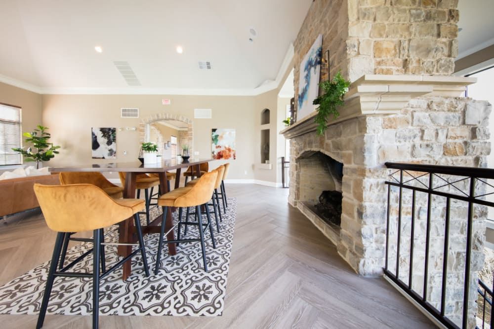 Clubhouse with fireplace and seating areas at Marquis at Treetops in Northwest Austin, TX.