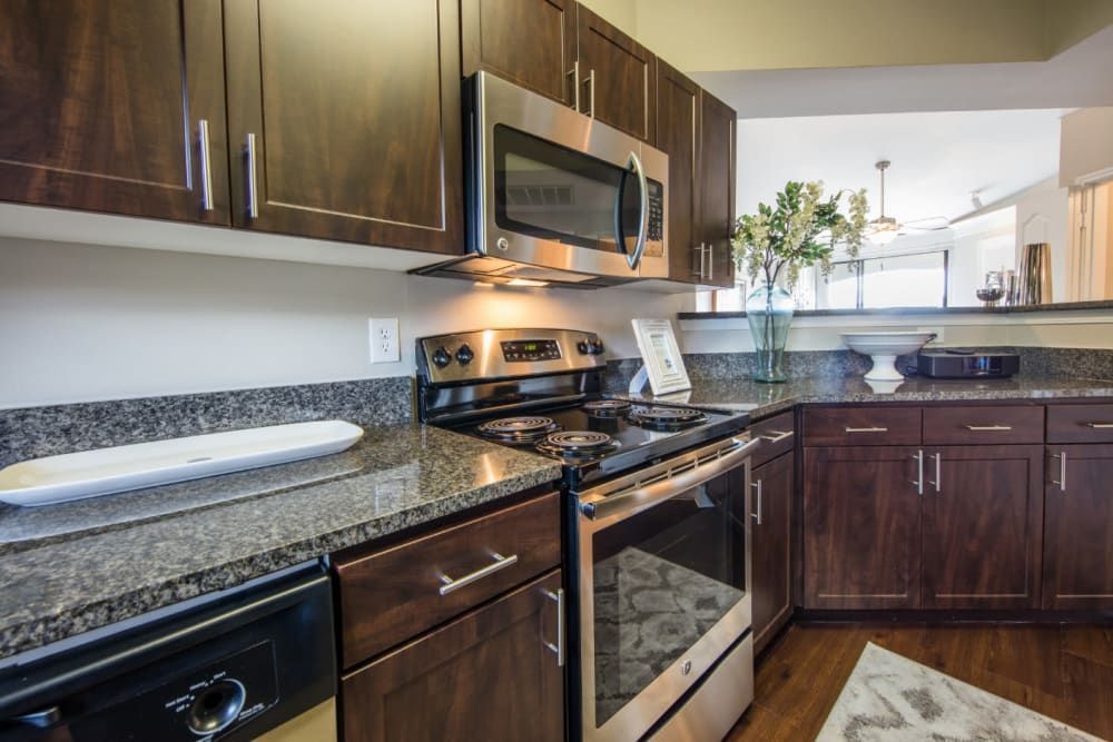 Apartment kitchen with stainless steel appliances and granite counter tops at Marquis at Treetops in Northwest Austin, TX.