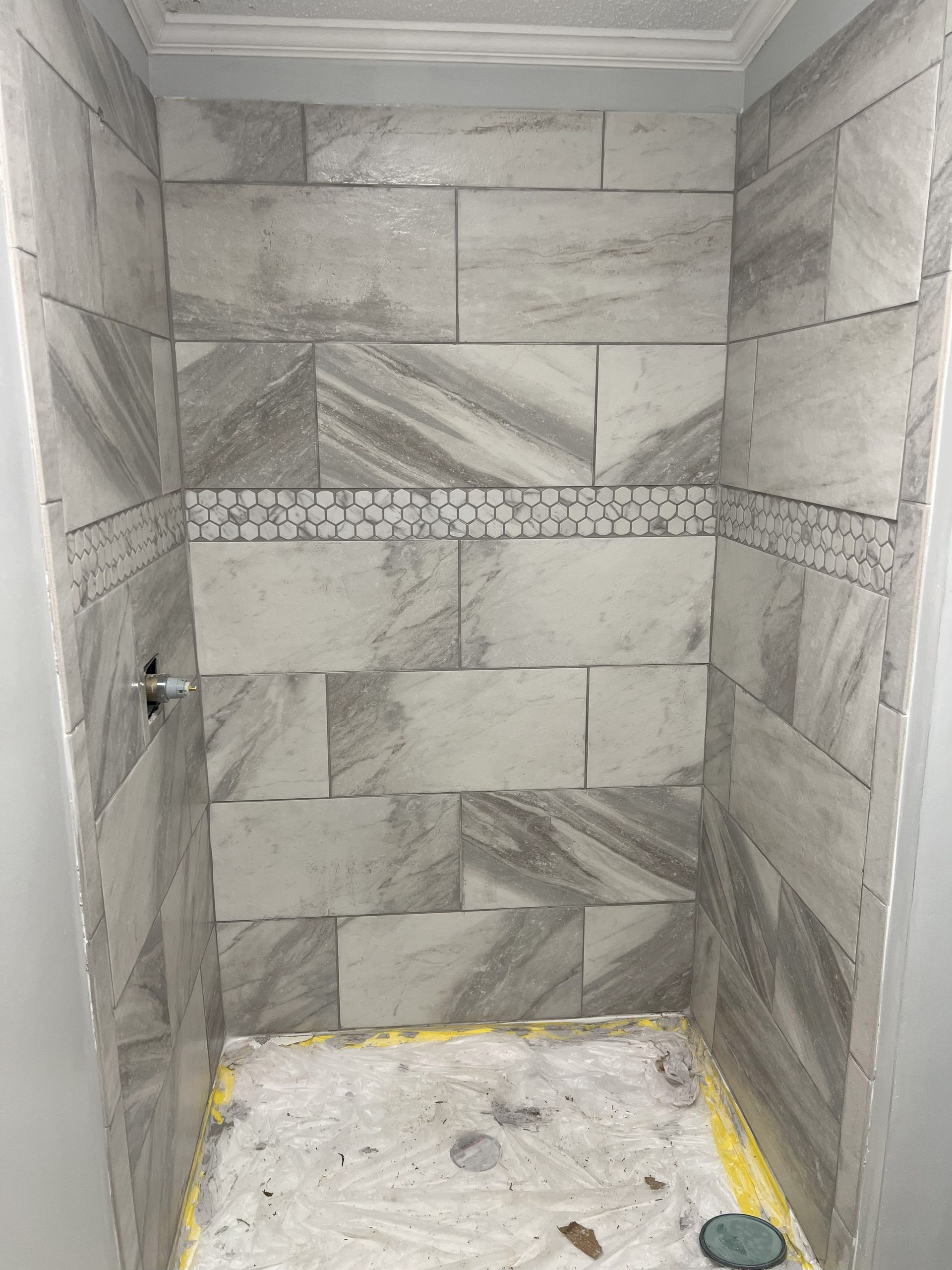 WP Home Repair - Bathroom Renovation - A shower stall with tiles on the wall and floor.