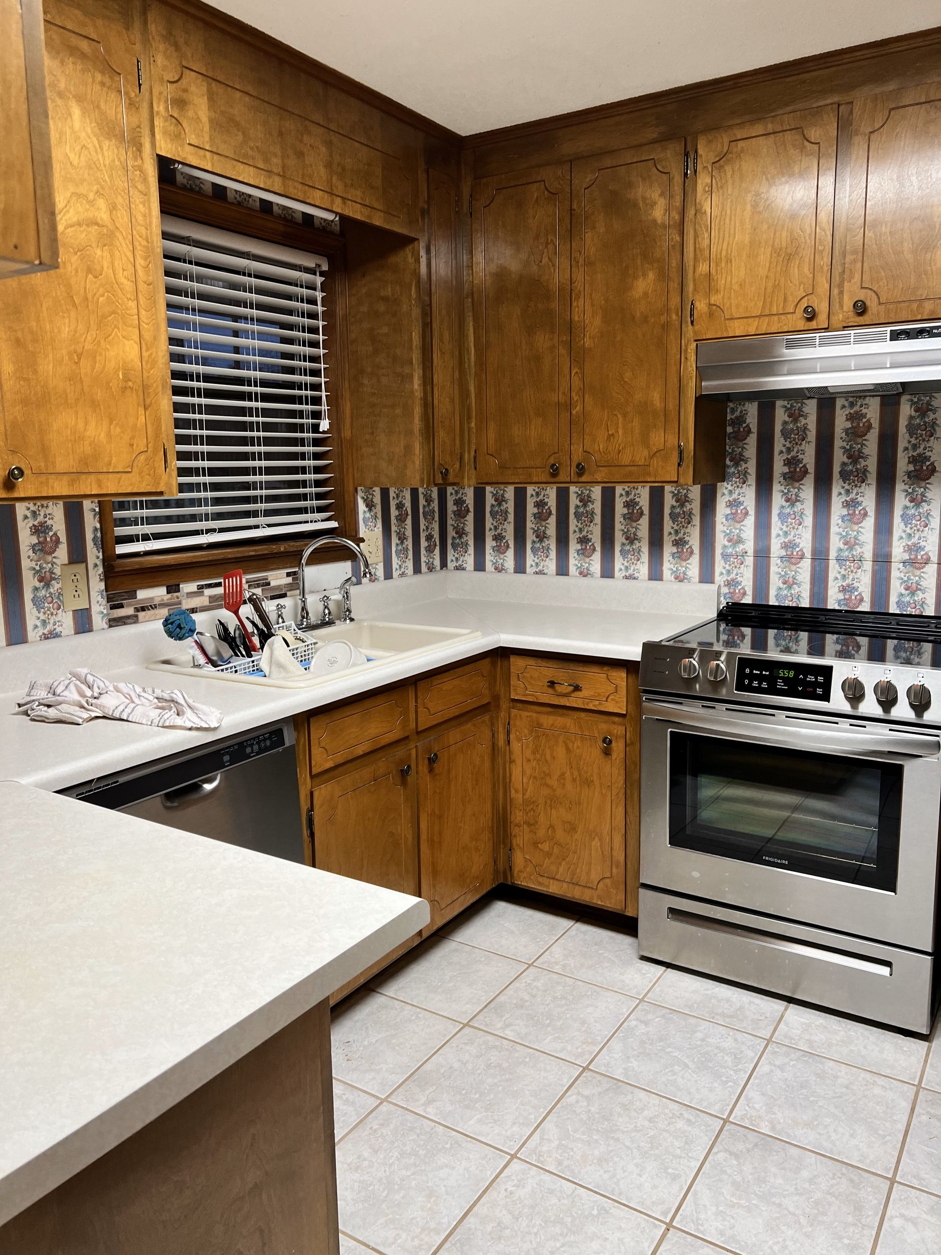 A kitchen with stainless steel appliances and wooden cabinets