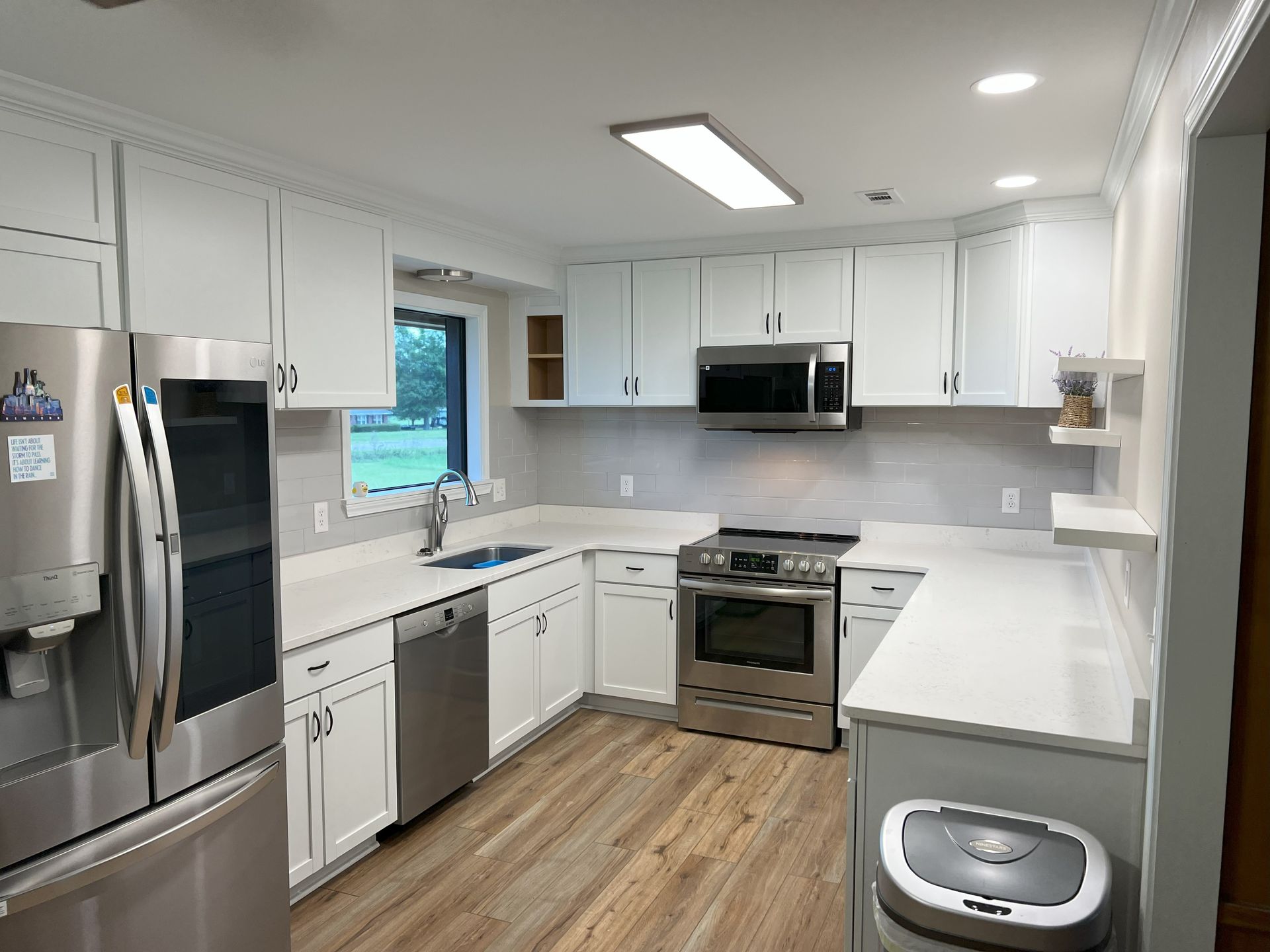 A kitchen with white cabinets and stainless steel appliances.