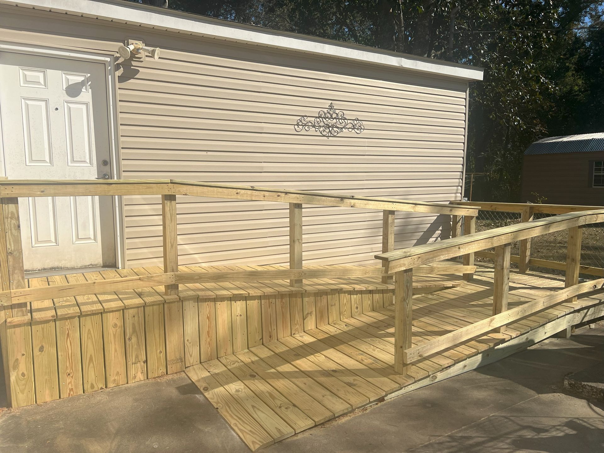 A wooden ramp is built into the side of a house.