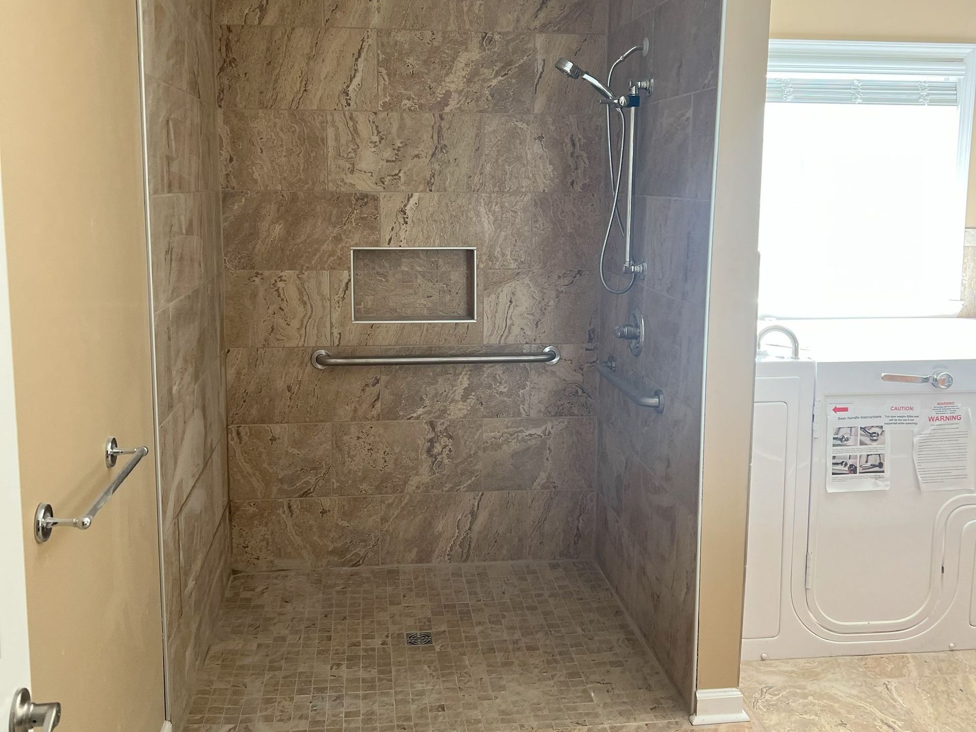 A bathroom with a walk in shower and a window.