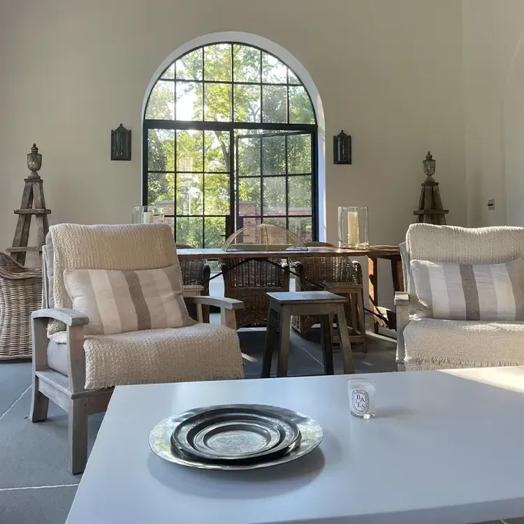 A living room with two chairs and a table with a plate on it