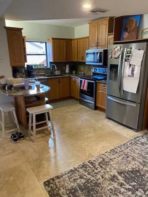 A kitchen with stainless steel appliances and wooden cabinets