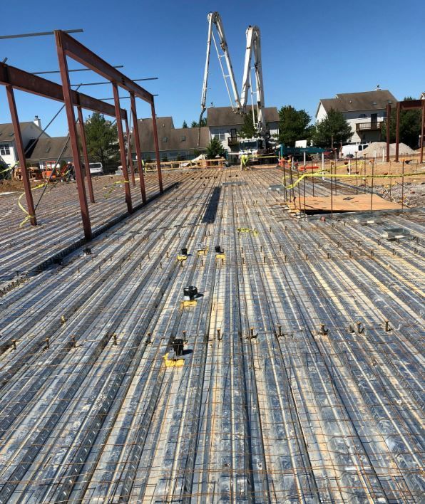 A construction site with a concrete pump in the background