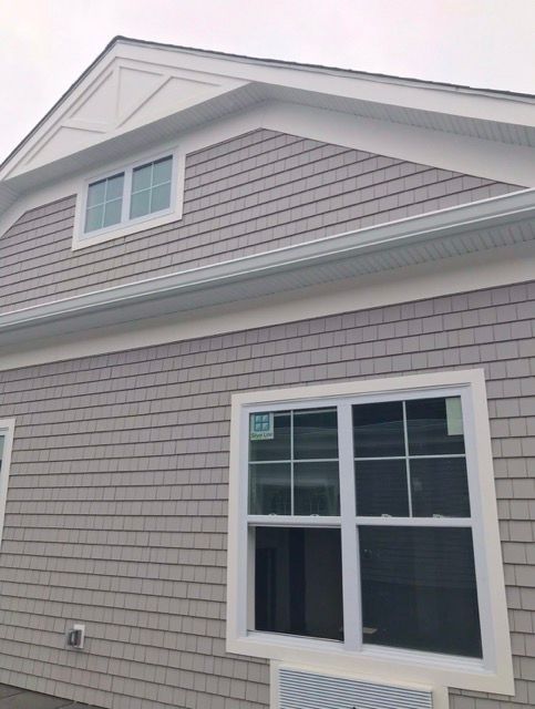 A house with a white roof and a white window