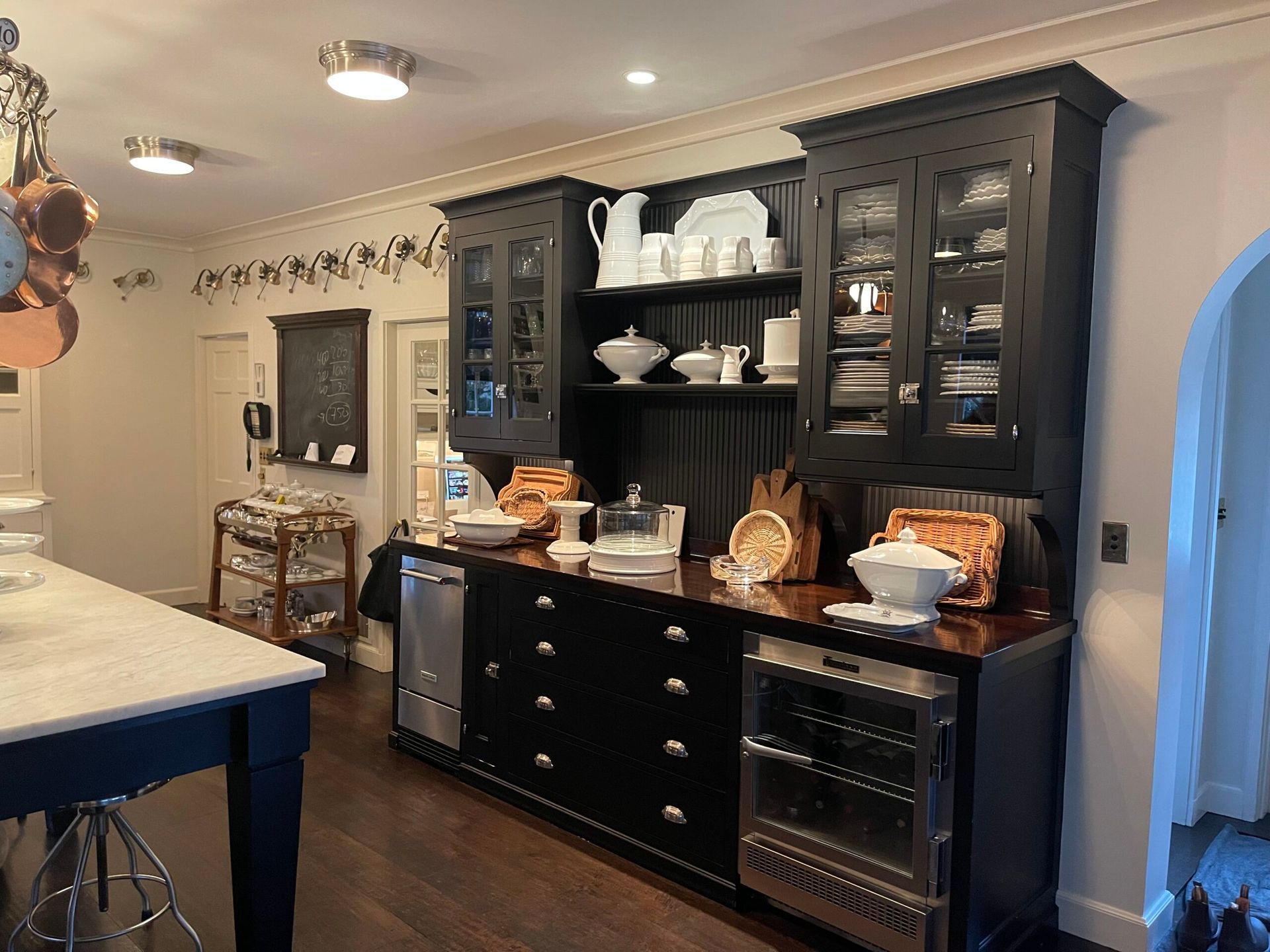 A kitchen with black cabinets and stainless steel appliances