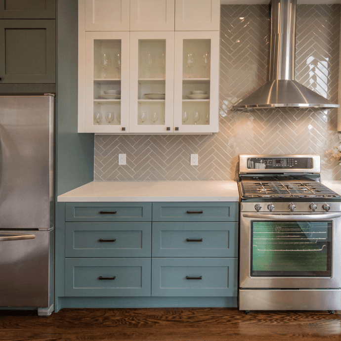 A kitchen with stainless steel appliances and blue cabinets