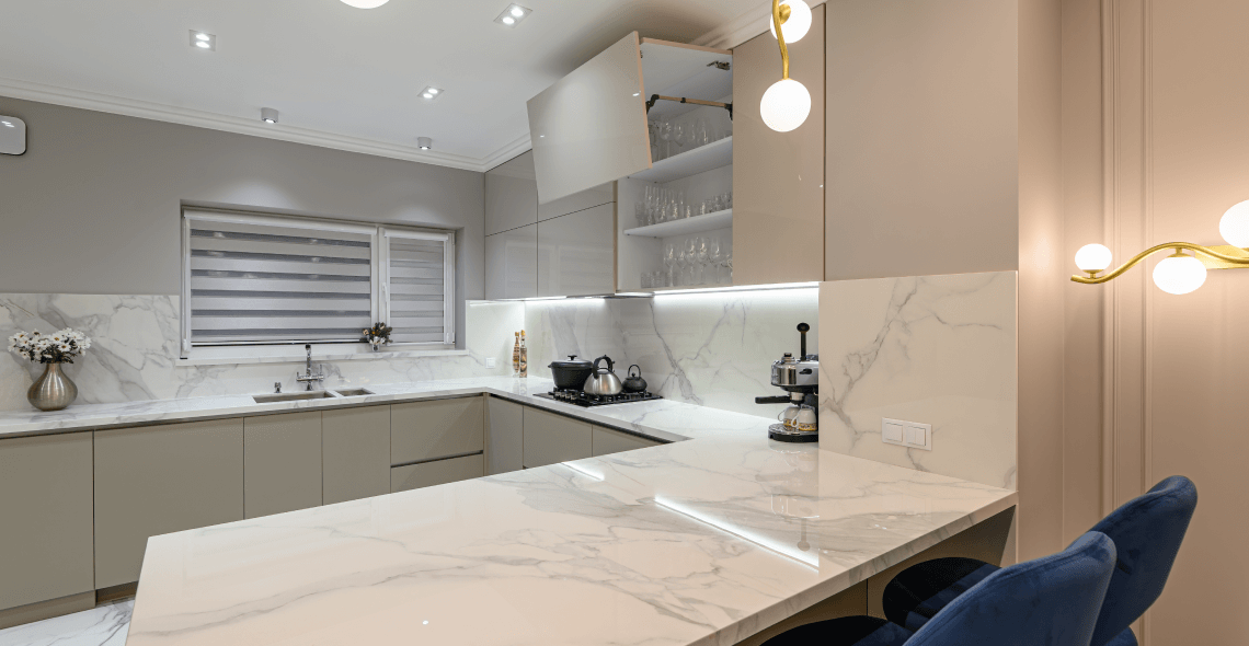 A kitchen with a marble counter top and a window.