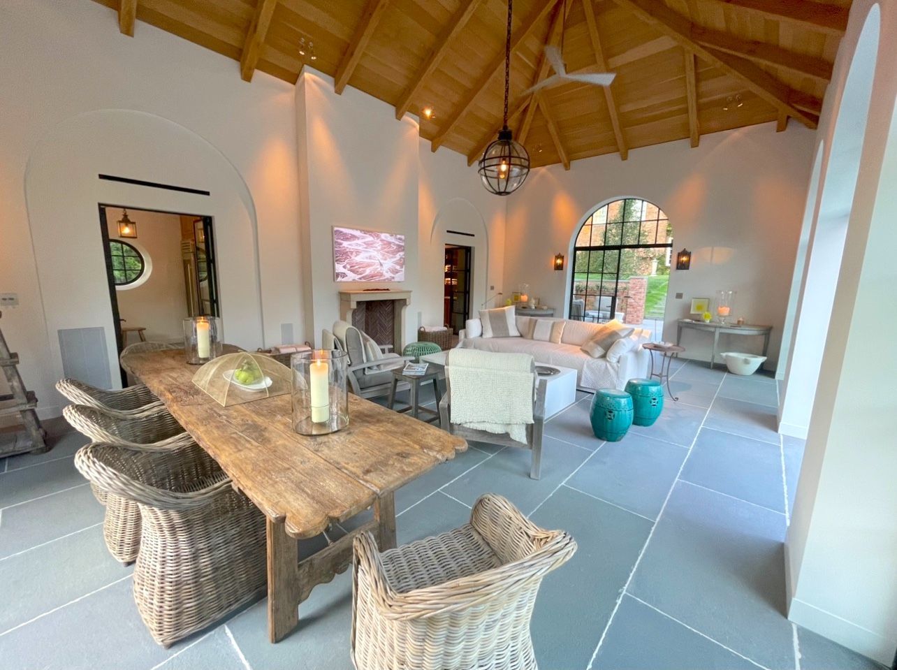 A large living room with a wooden table and chairs