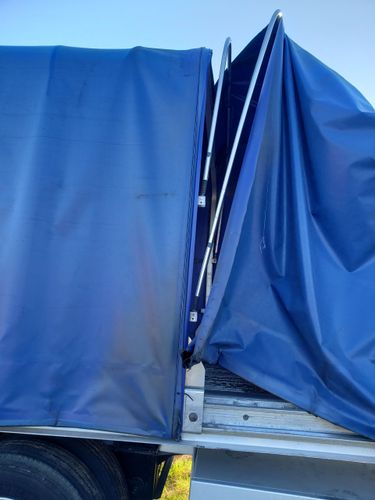 Blue wall with patched sections; light blue, medium blue, and dark blue patches.