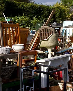 A bunch of chairs and tables are stacked on top of each other