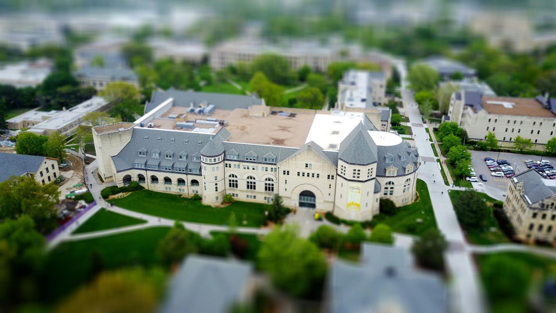 An aerial view of a castle surrounded by buildings and trees.