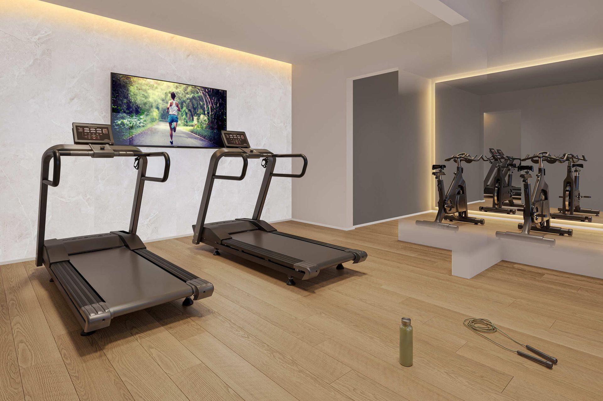 Academia com esteiras, bicicletas ergométricas, TV e piso de madeira.